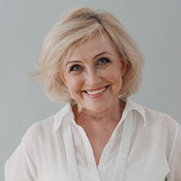 An older man smiling at his dentist