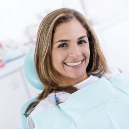 Smiling woman leaning back in dental chair