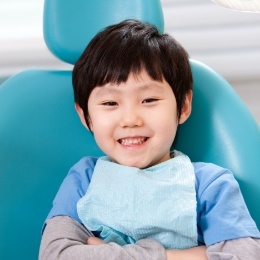 Young boy smiling in dental chair