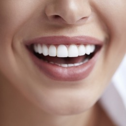 Close up of person smiling with flawless white teeth