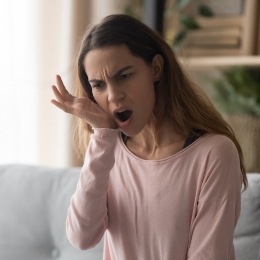 Woman holding her jaw in pain