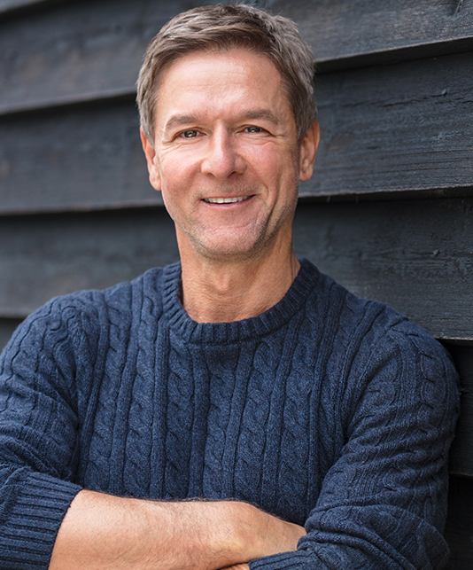 Smiling older man in dark blue sweater