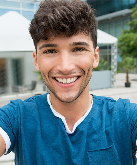 Smiling young man in blue tee shirt