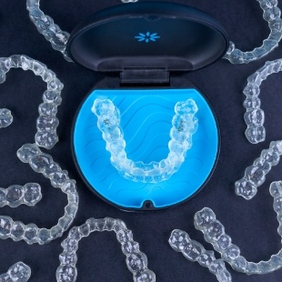 Several Invisalign clear aligners in Nepean on a table