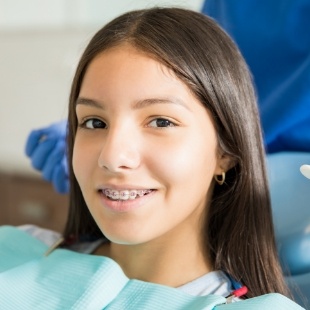 Teenage girl with braces smiling in the dental chair