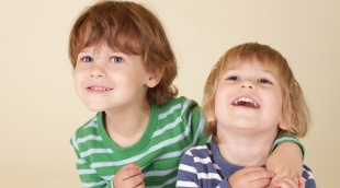 Two children smiling together