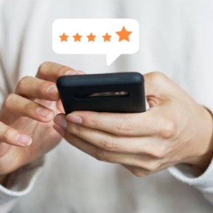 Person leaving a five star review on their phone